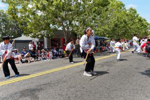 Kids showing bo staff skills at parade